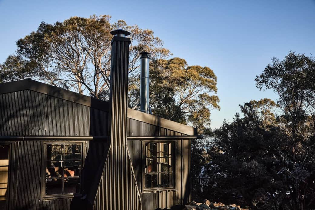 Exterior shot of Camp Nowhere at sunset with gum trees in the distance.