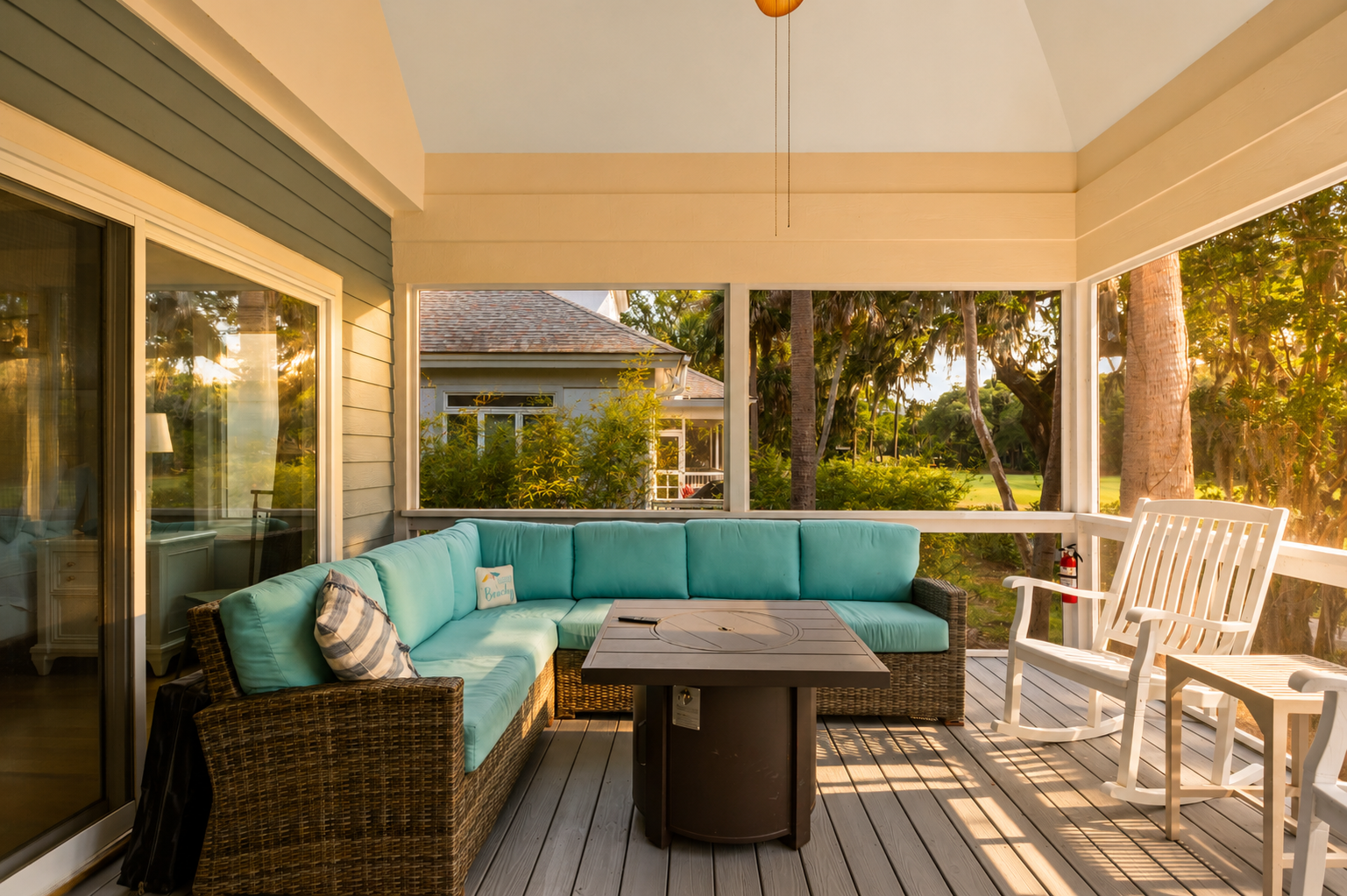 Relax on the screened patio with comfortable lounge seating and peaceful views of the greenery.