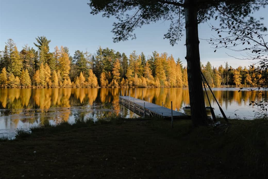 Breathtaking view of a serene lake, basking in the warm glow of a vibrant sunset. Breathtaking view of a serene lake, basking in the warm glow of a vibrant sunset.