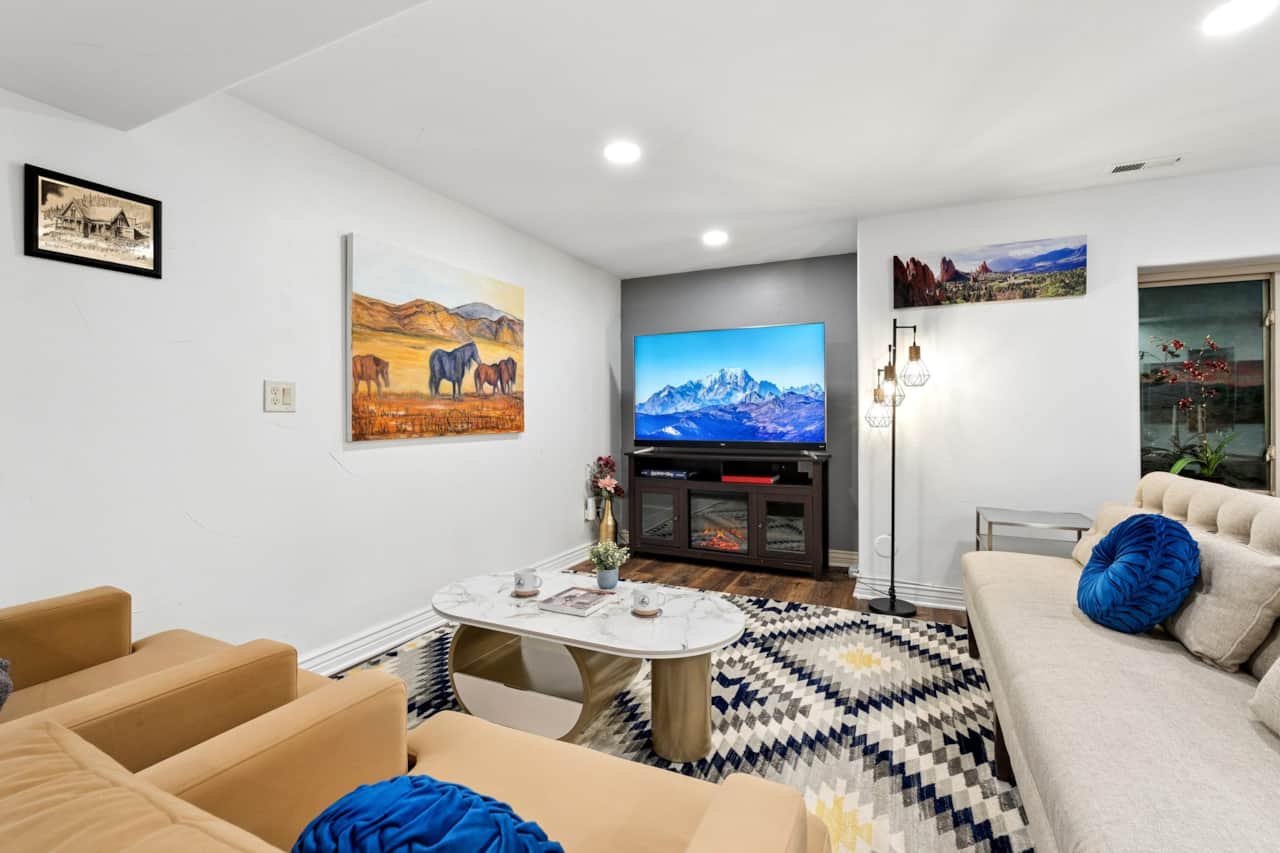 Private lounge — large smart TV, electric fireplace, desk nook