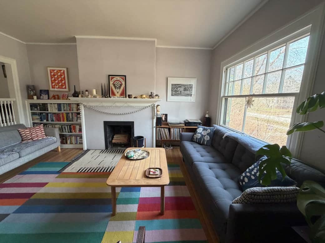 Light-filled living room with original architectural details—comfortable, open, and easy for gathering and reading/listening to music.