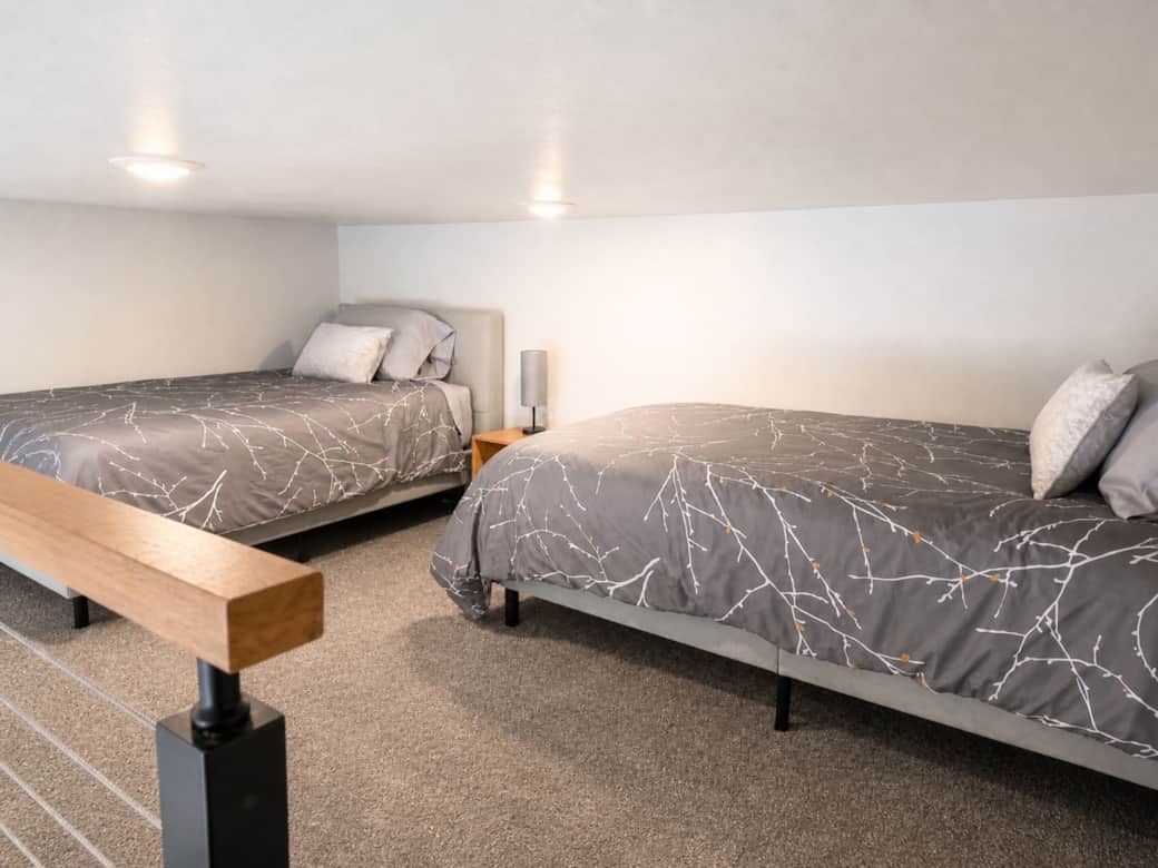 Sleeping loft with two twin beds and premium linens in the Black Hills, SD.