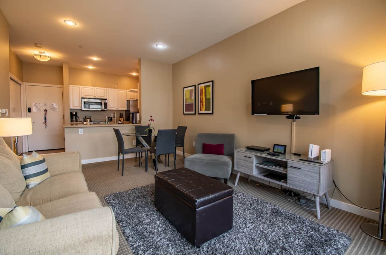 Spacious Living Room with a Private Balcony Overlooking the Serene Courtyard Garden 