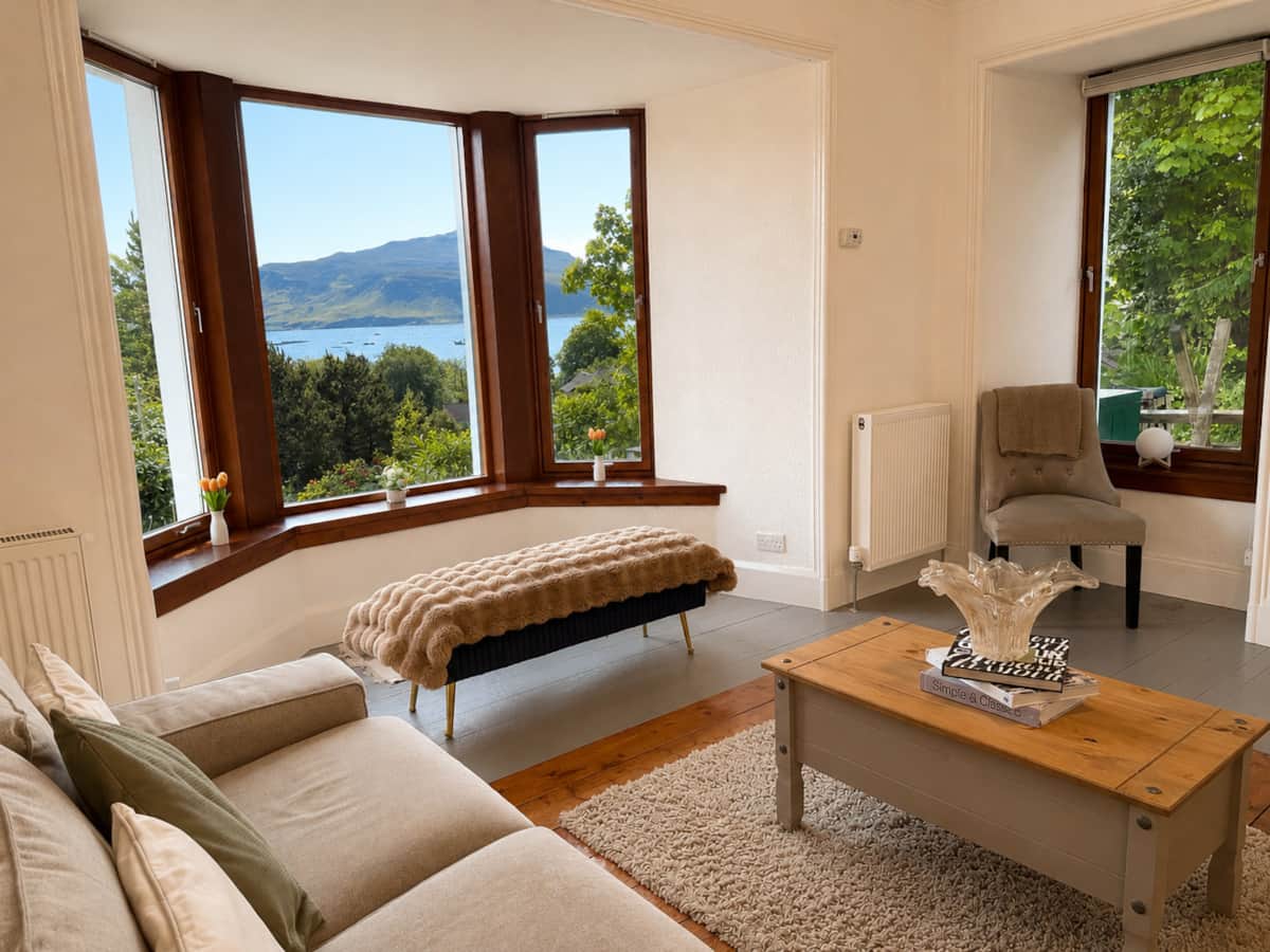 Living room bay window looking out over Loch Portree to the hills.