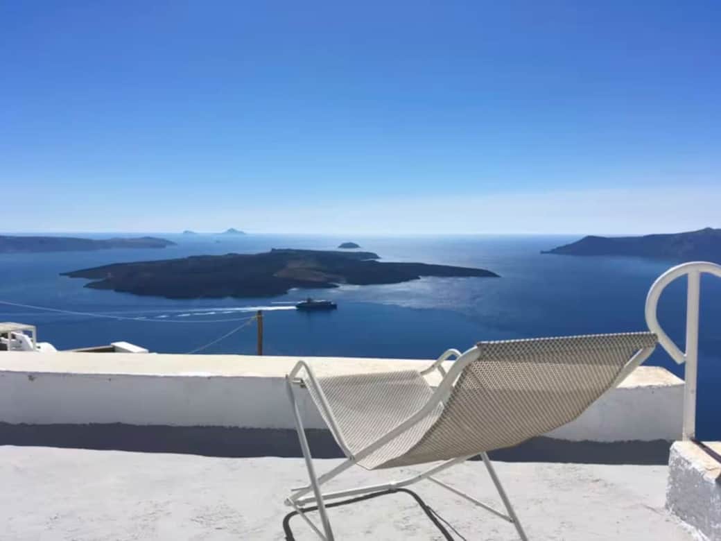 Relax on the large terrace with panoramic Caldera vistas in Santorini.