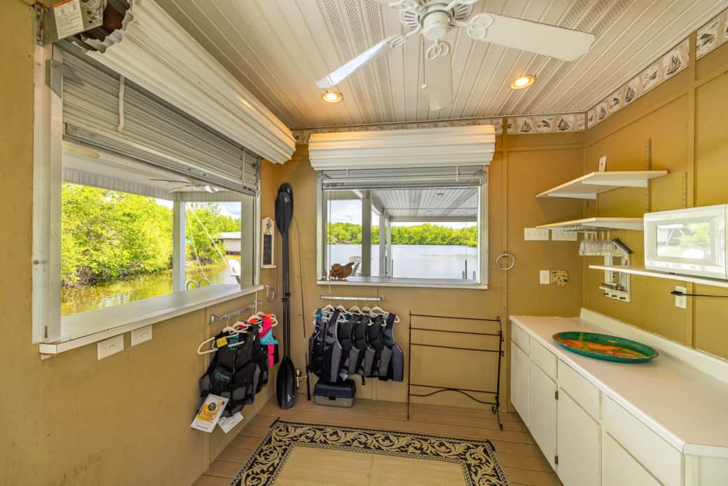 Kitchenette is Equipped with Fridge, Microwave, and Storage for Life Vests and Fishing Poles