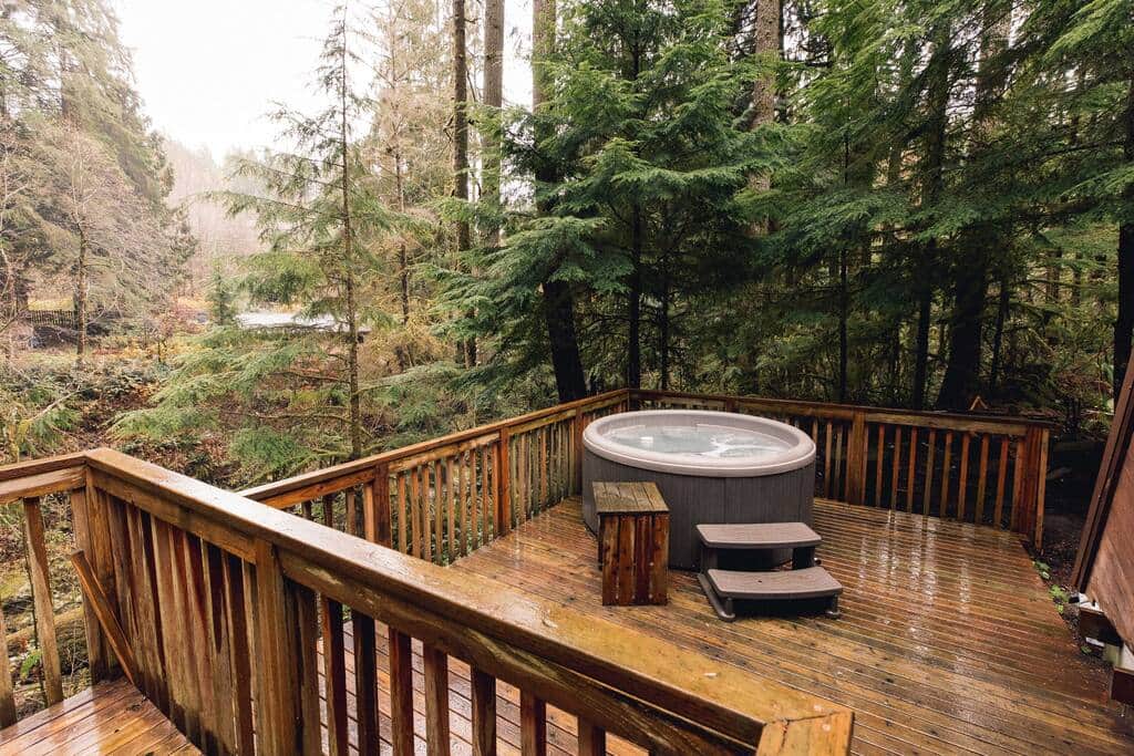 The hot tub is on the back porch and has great views of the river and the surrounding trees. The hot tub is on the back porch and has great views of the river and the surrounding trees.