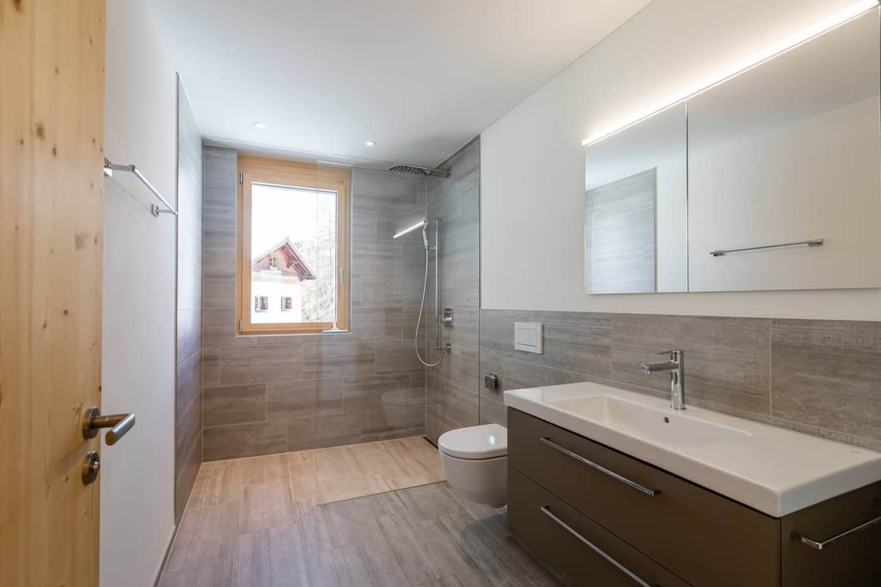 Modern tiles, quality fixtures, and warm lighting give each bathroom a fresh, clean, and elegant feel.