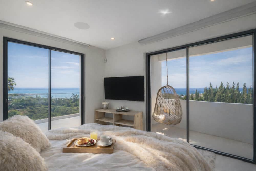 Bedroom of Villa Luz Bliss with floor-to-ceiling windows facing the sea