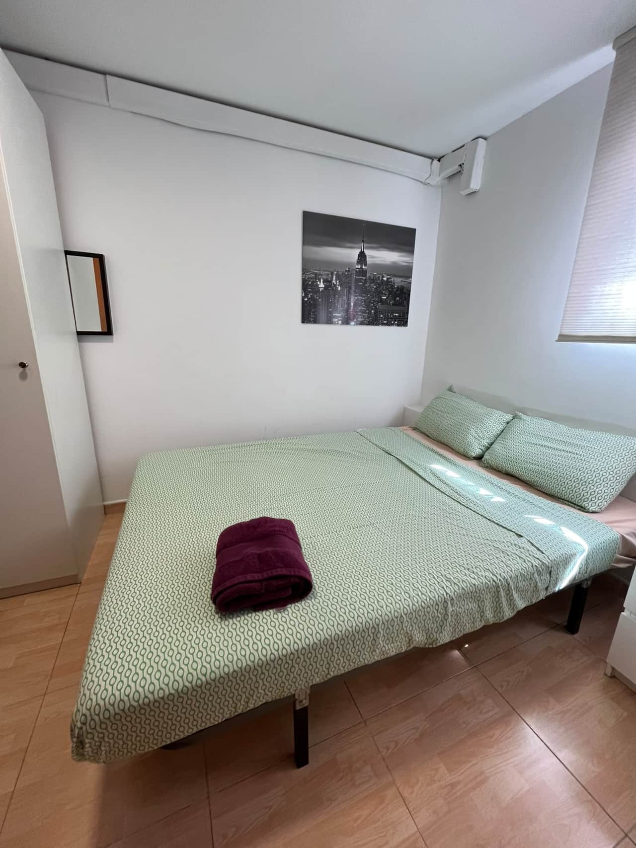 Bedroom with double bed, wardrobe and window