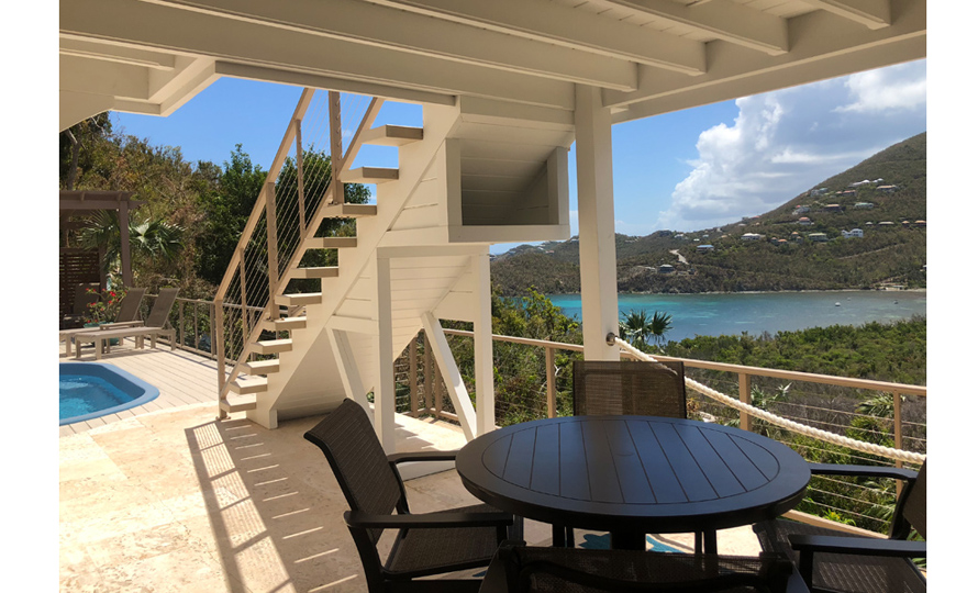 Staircase leading to the pool deck from the upper level porch off the main living area