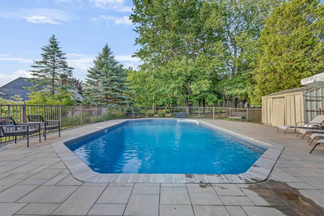 Soak up the sun or take a dip in the heated pool. Perfect for both relaxation and play with a shallow end for lounging and a deep end for diving in. Surrounded by chaise lounges, chairs, and benches, it’s your private summer sanctuary.