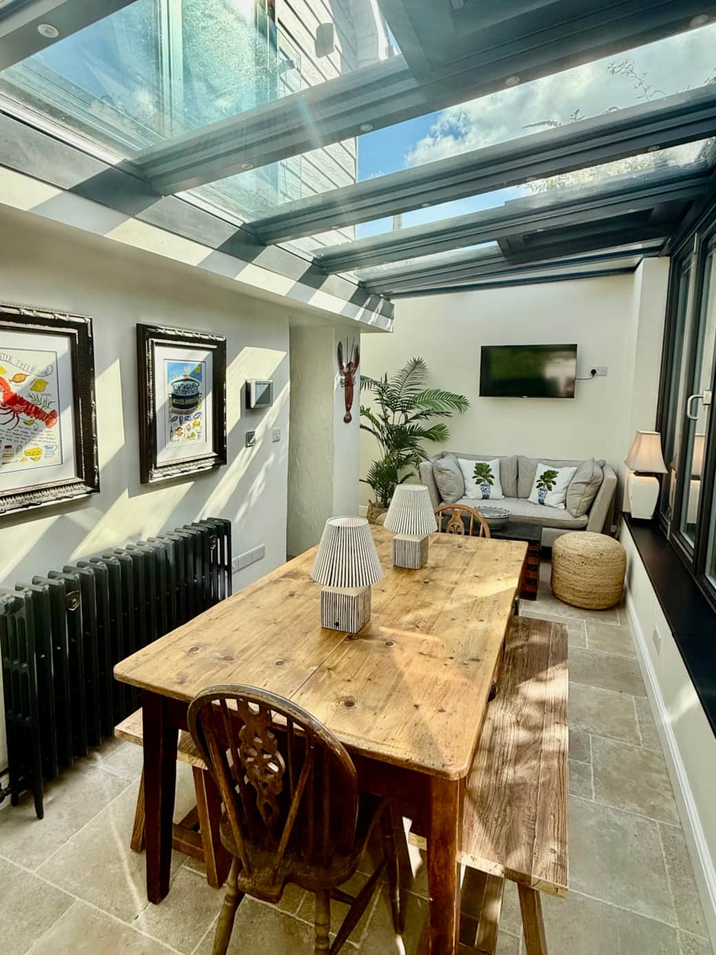 Spacious dining area with large rustic wooden table and vintage bifold doors