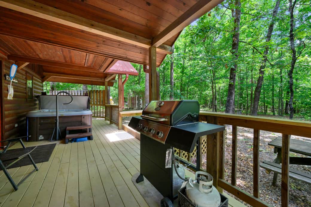 Back deck showing open hot tub and grill