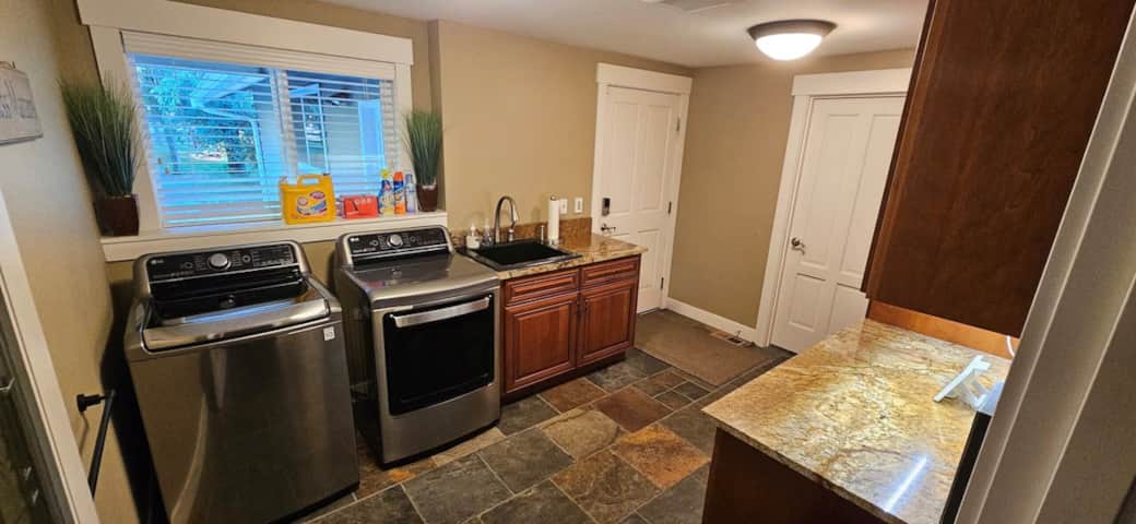 Large, fully stocked laundry room, with mud sink and access to the garage., expand to full screen vi