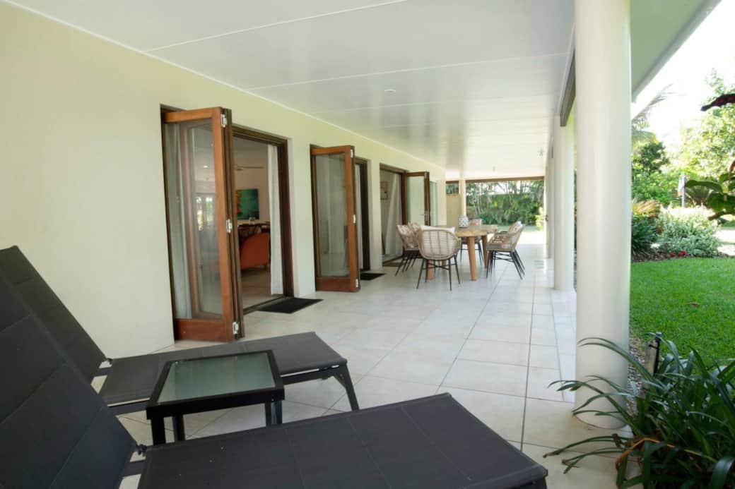 Alani - Beachfront patio with dining table and sun lounges