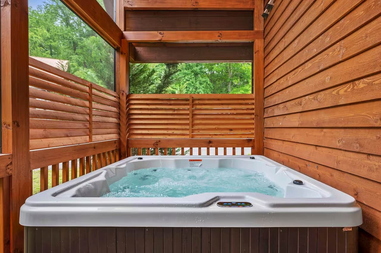 Relax and unwind in your private, covered hot tub surrounded by peaceful wooded views