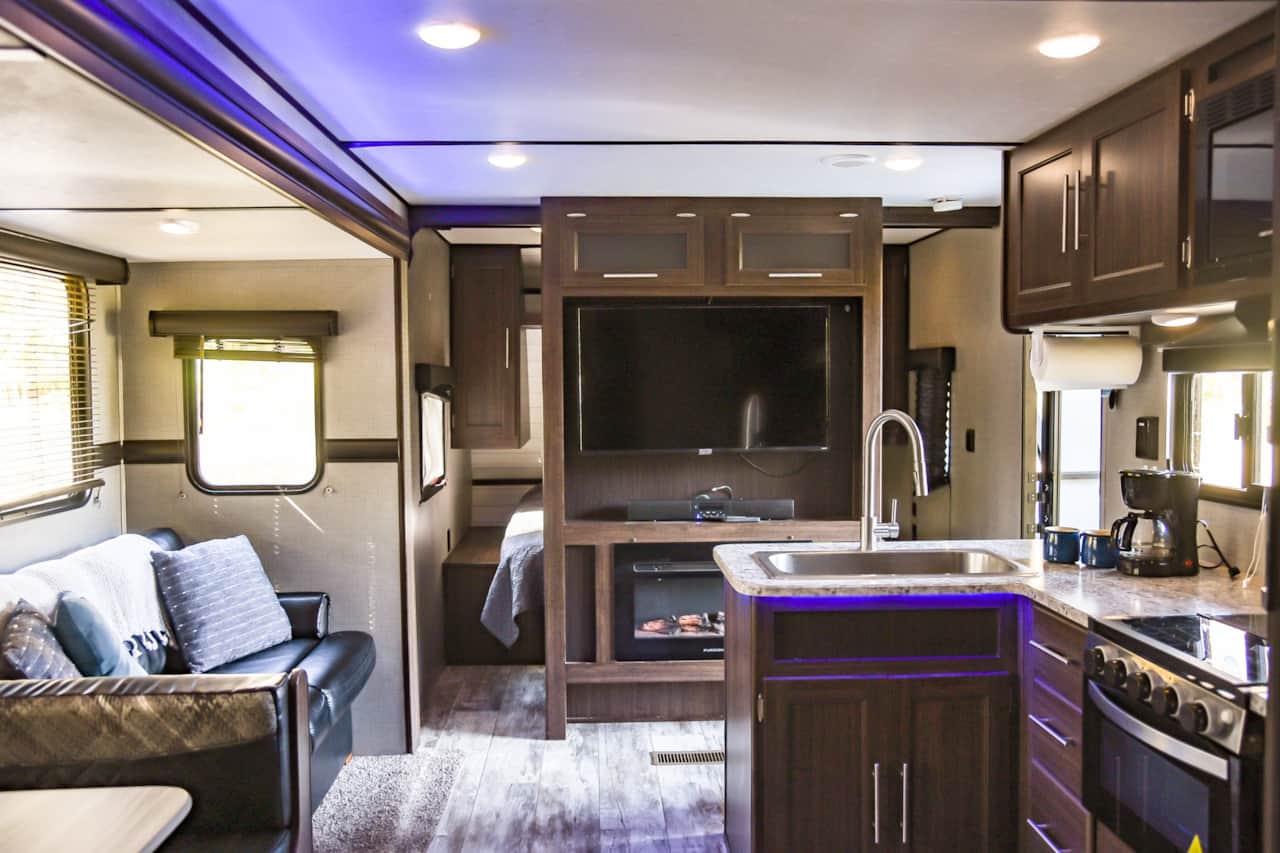 view of tv/fireplace and kitchen from bunkroom entrance