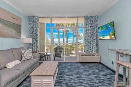 Spacious living room with walk-out 1st-floor balcony, ocean views, and easy access to all resort ame
