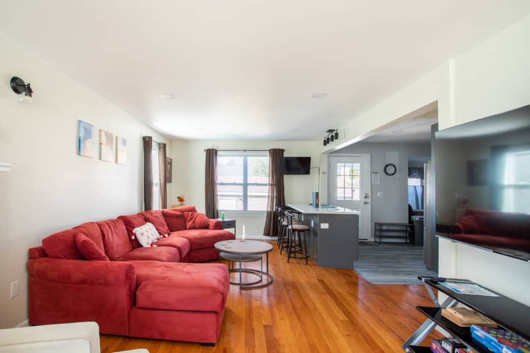 Living Room: Bright space with plush seating and open kitchen, perfect for socializing and relaxing!