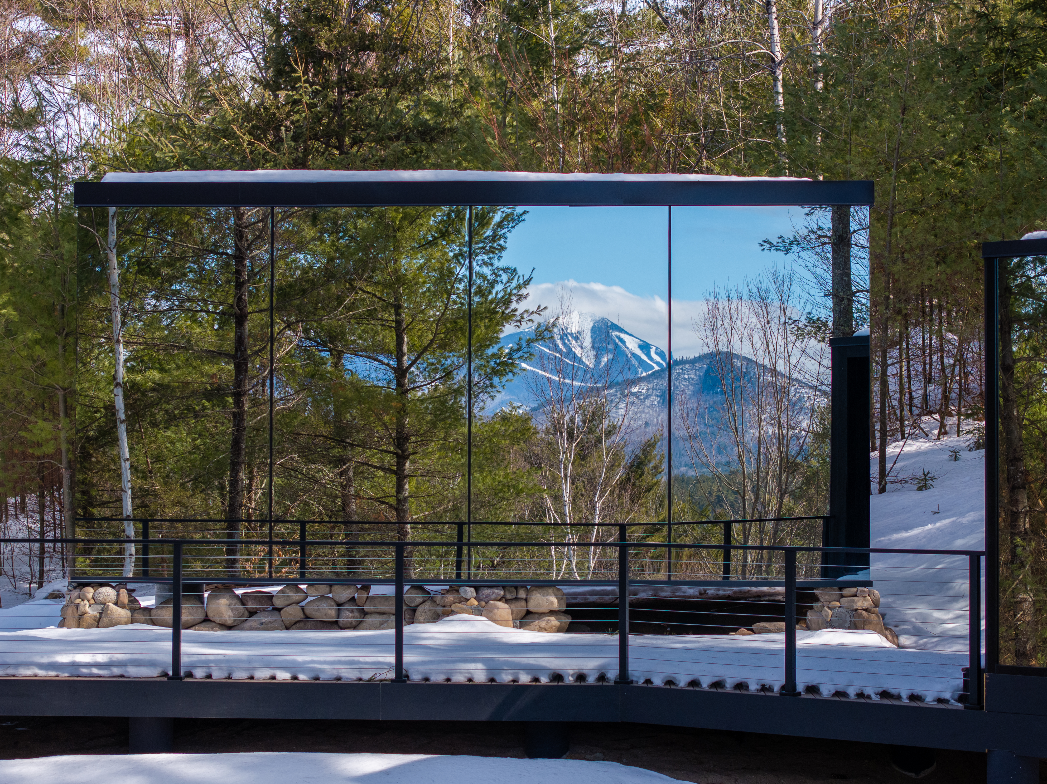 ÖÖD Whiteface at Jay exterior glass reflecting Whiteface Mountain ski trails