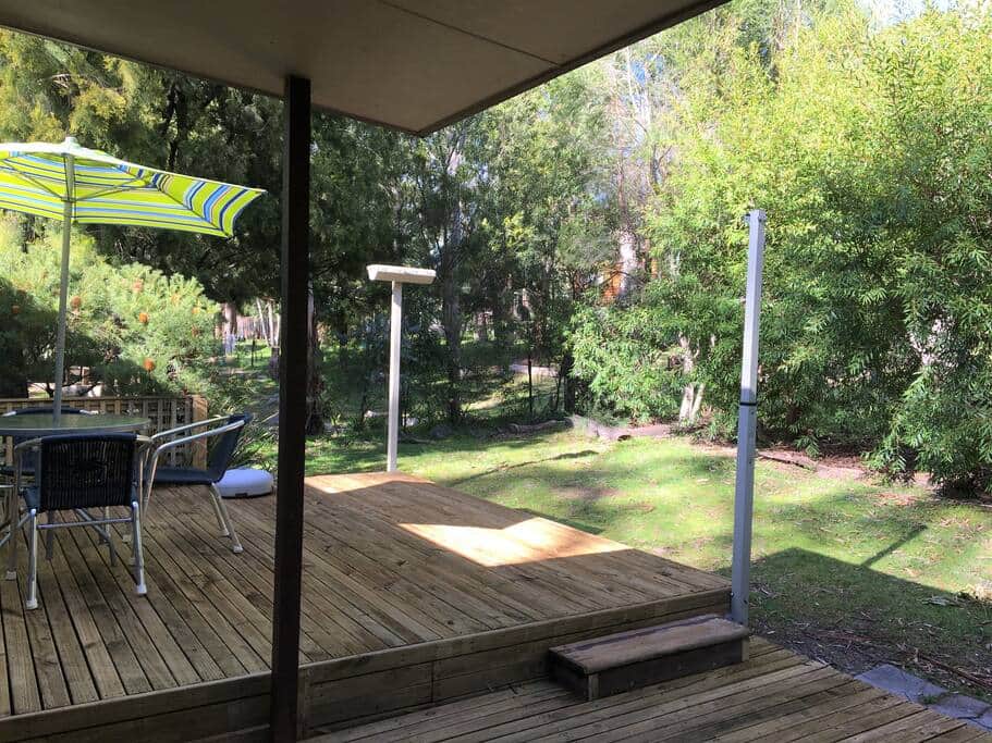 Escape to our serene rear deck for tranquil relaxation, morning coffee, and evening stargazing. Escape to our serene rear deck for tranquil relaxation, morning coffee, and evening stargazing.