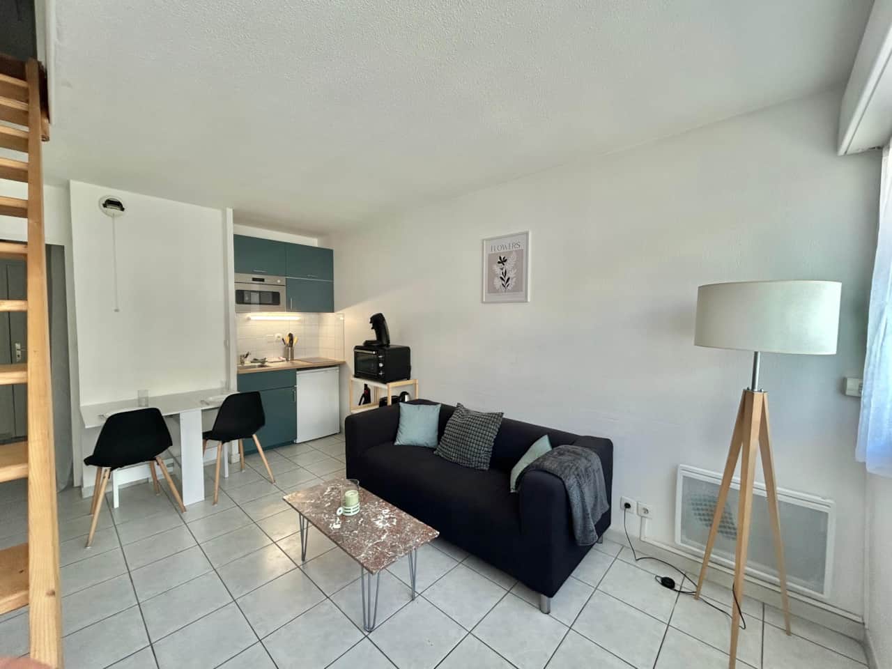 Living room, sofa, dining table, chairs, lamp, coffee table, kitchen, micro wave, TV, stairs