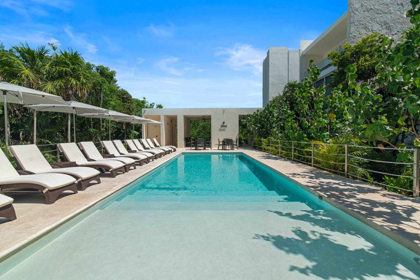 Experience bliss at our poolside oasis, featuring sun-soaked loungers and shaded umbrellas for you to enjoy during your stay.