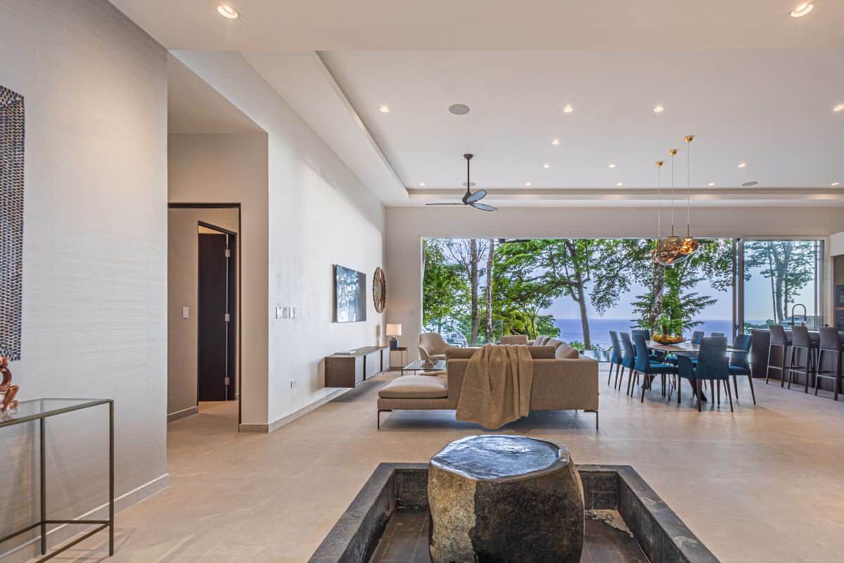 Open-plan luxury living room at Villa Sueño with panoramic ocean and jungle views.