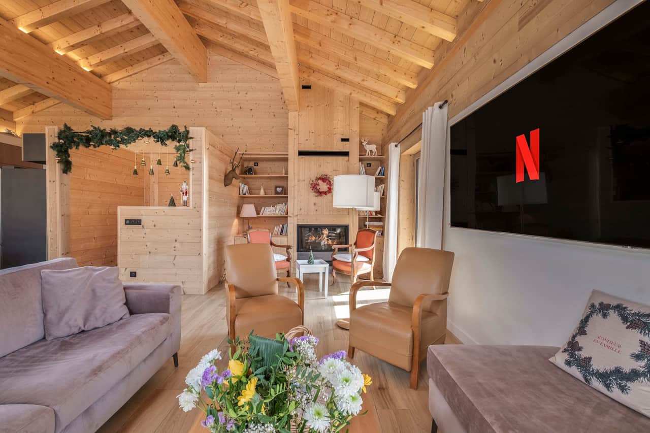 Cozy living room with modern fireplace and large flat screen TV, perfect for relaxing evenings.