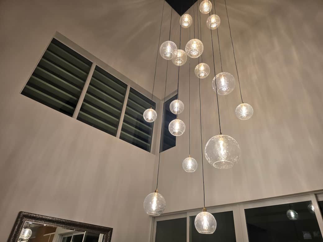 View of the dining room custom chandelier at night
