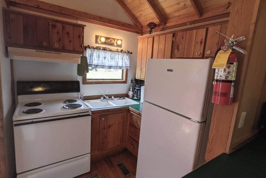 "Ole Pete" tiny home cabin #14 has a full kitchen for all of your cooking and baking needs.
