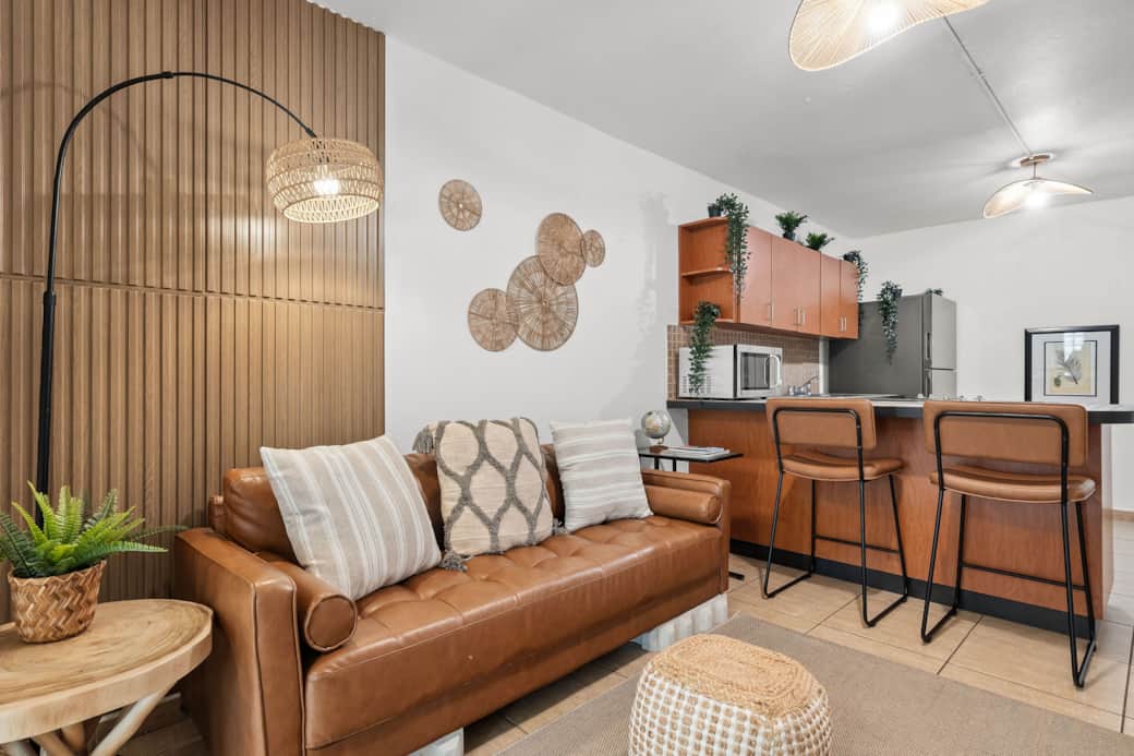 Warm, stylish living space with rattan accents and open kitchen