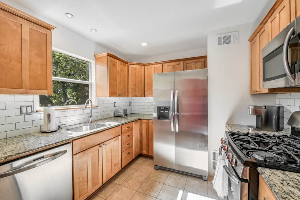 Kitchen is outfitted with new, modern stainless steel appliances. 