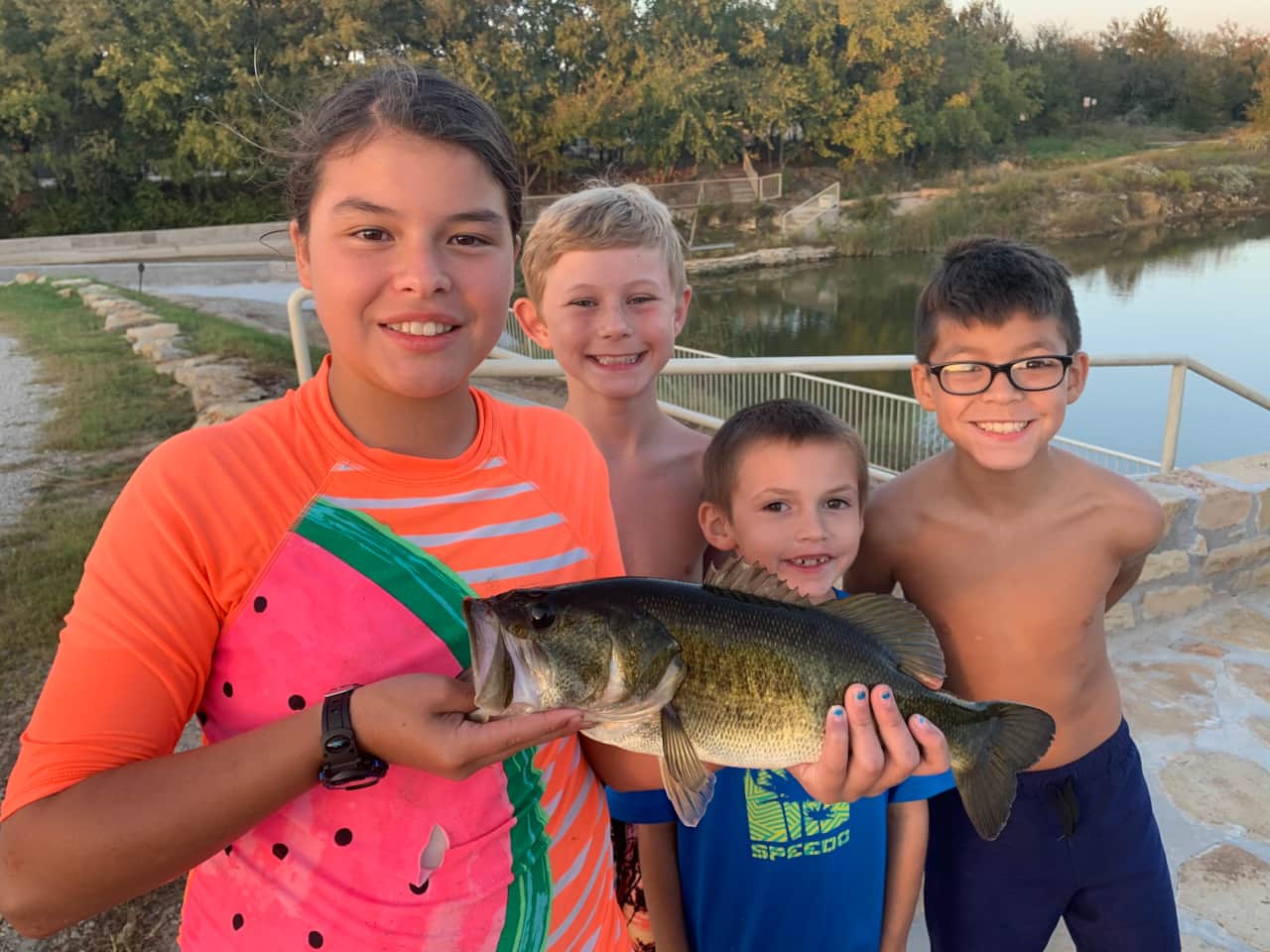 Children fishing for bass right from the Lake Godstone lodge dock during a Texas church retreat