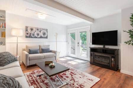 Relax in the light and bright living room with French doors that open wide onto the private deck