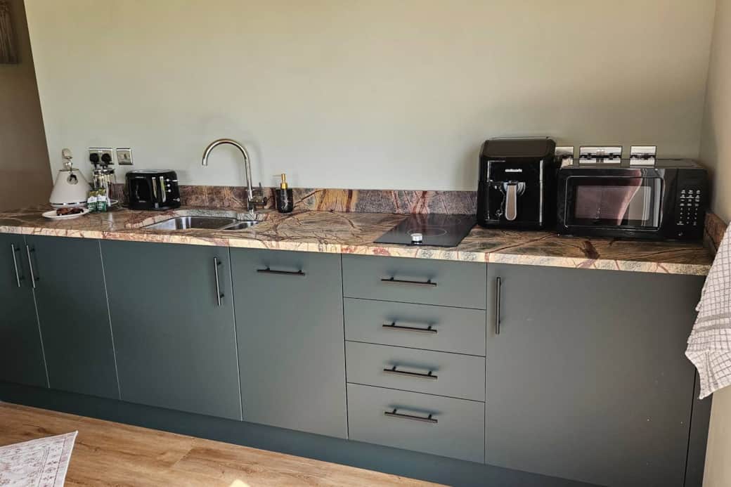 A compact but fully fitted kitchen . Air fryer/microwave/toaster/kettle/marble worktop. Built in fridge and dishwasher. Smart and functional