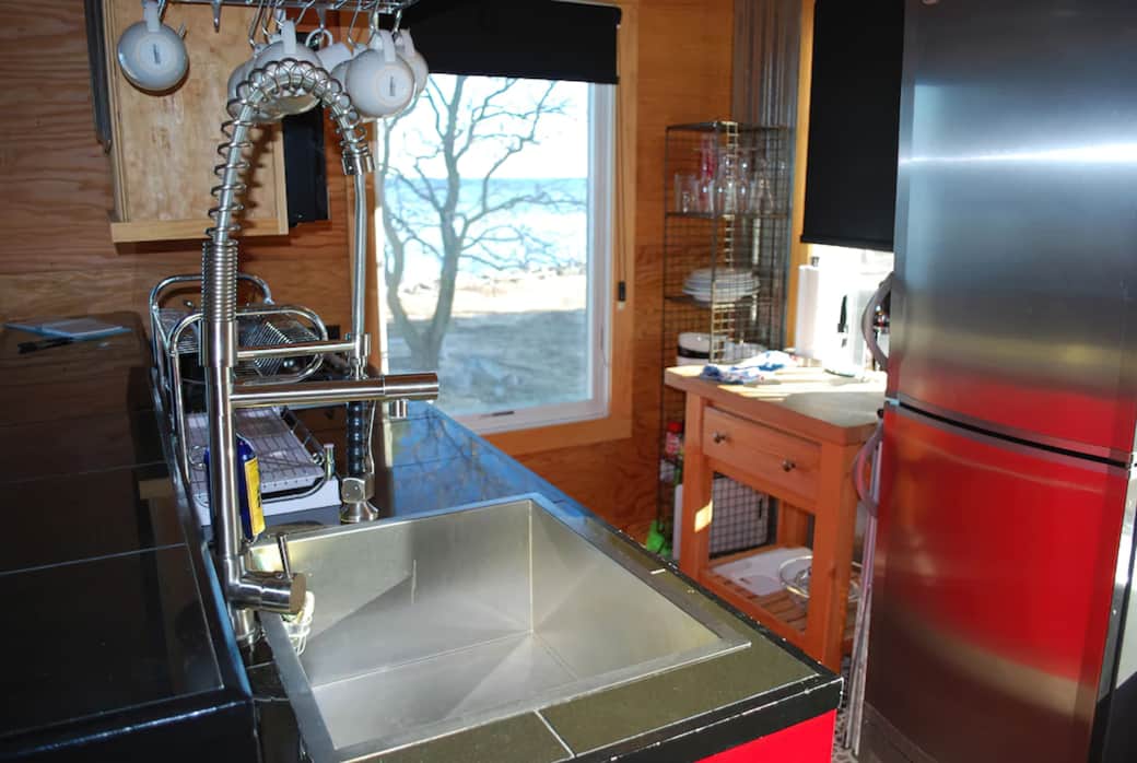 Kitchen with full refrigerator, gas cooktop, and convection microwave/oven Kitchen with full refrigerator, gas cooktop, and convection microwave/oven