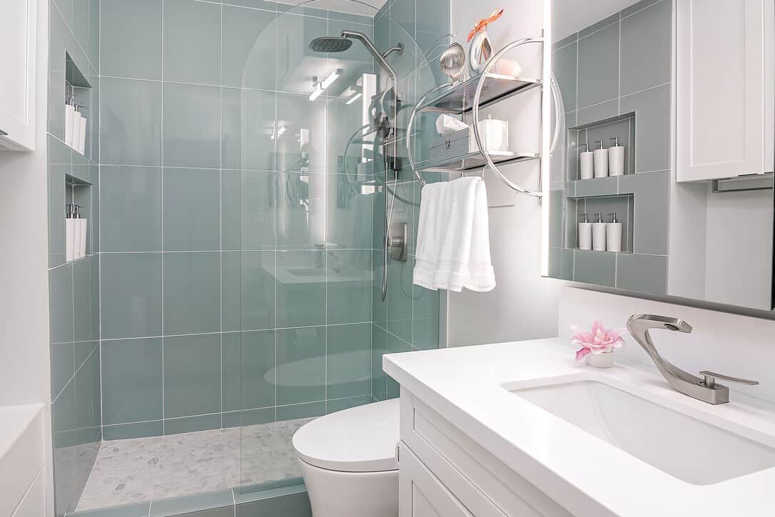 Soothing sea glass tiled shower with rainshower head and wand. Shampoo, conditioner, and body wash provided. Multi-function bidet toilet for the ultimate in cleanliness. 