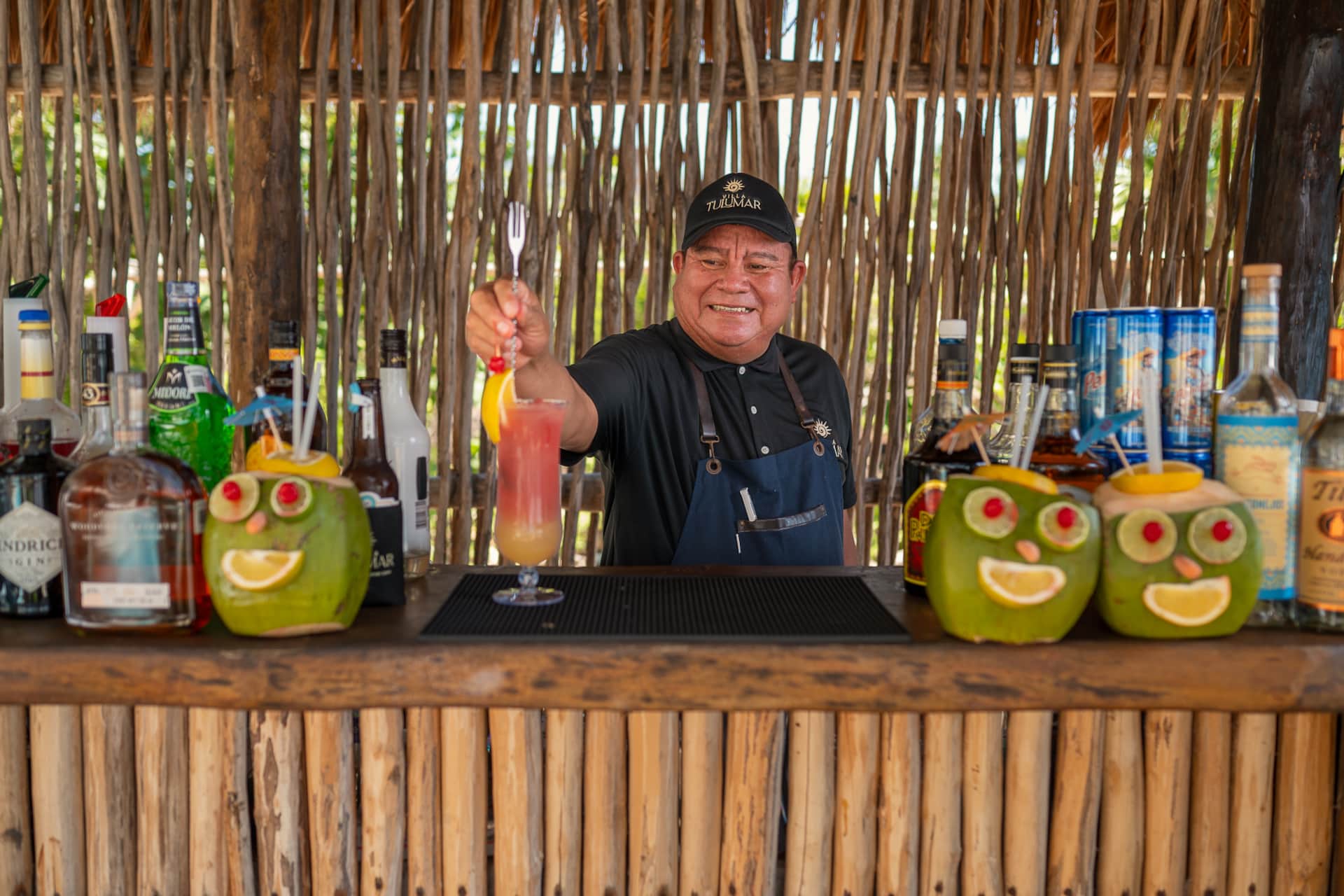 Bartender serving handcrafted cocktails by the pool at Villa TuluMar