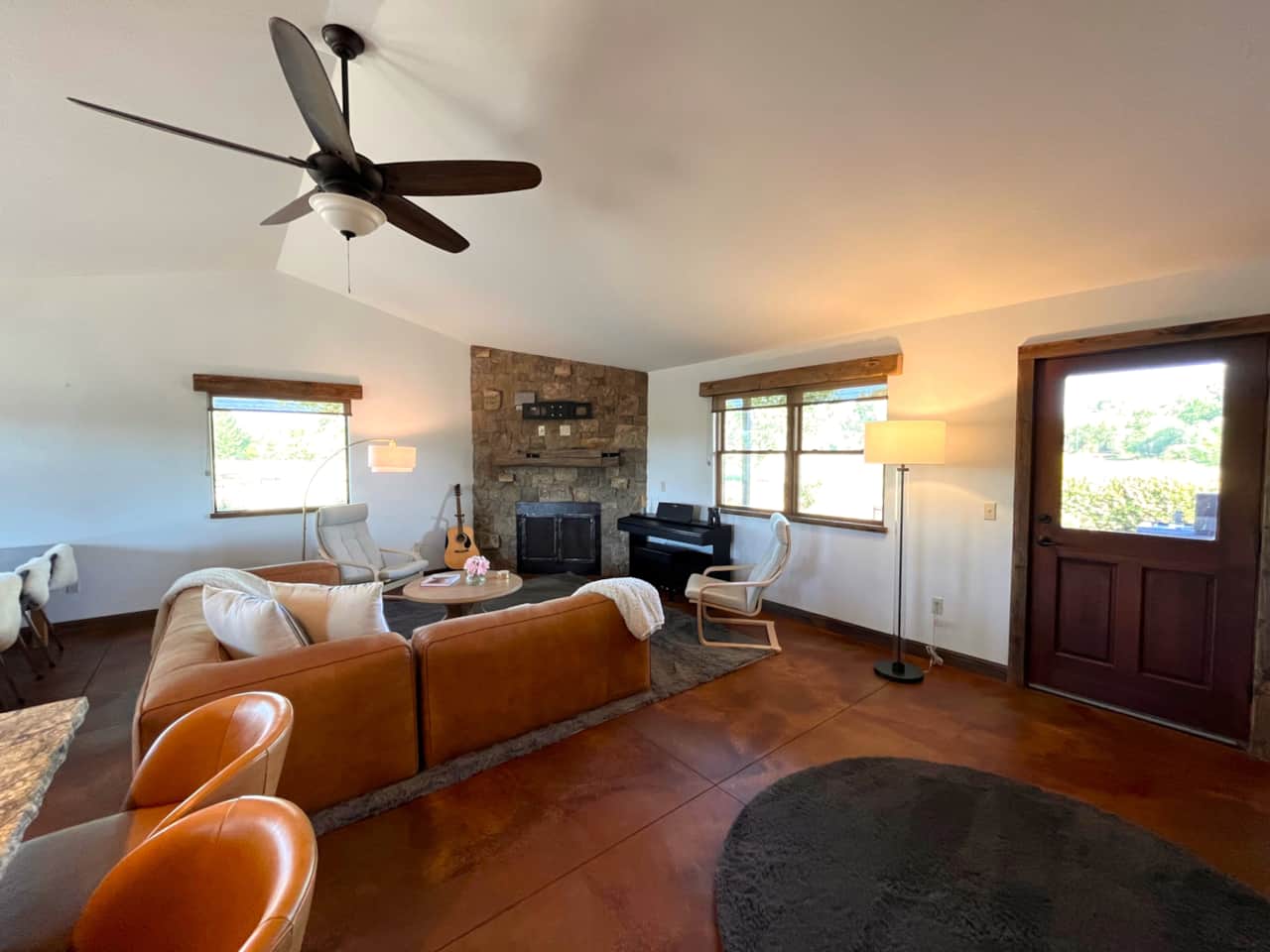The open living room area features a gas fireplace and piano