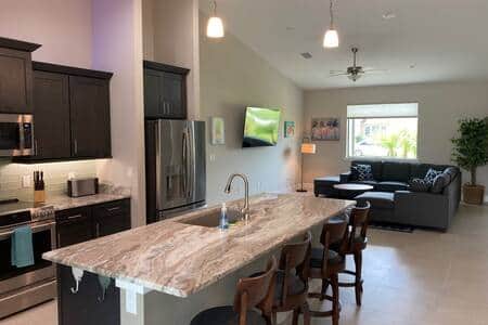 Bar has seating for 4, sofa and 60" TV