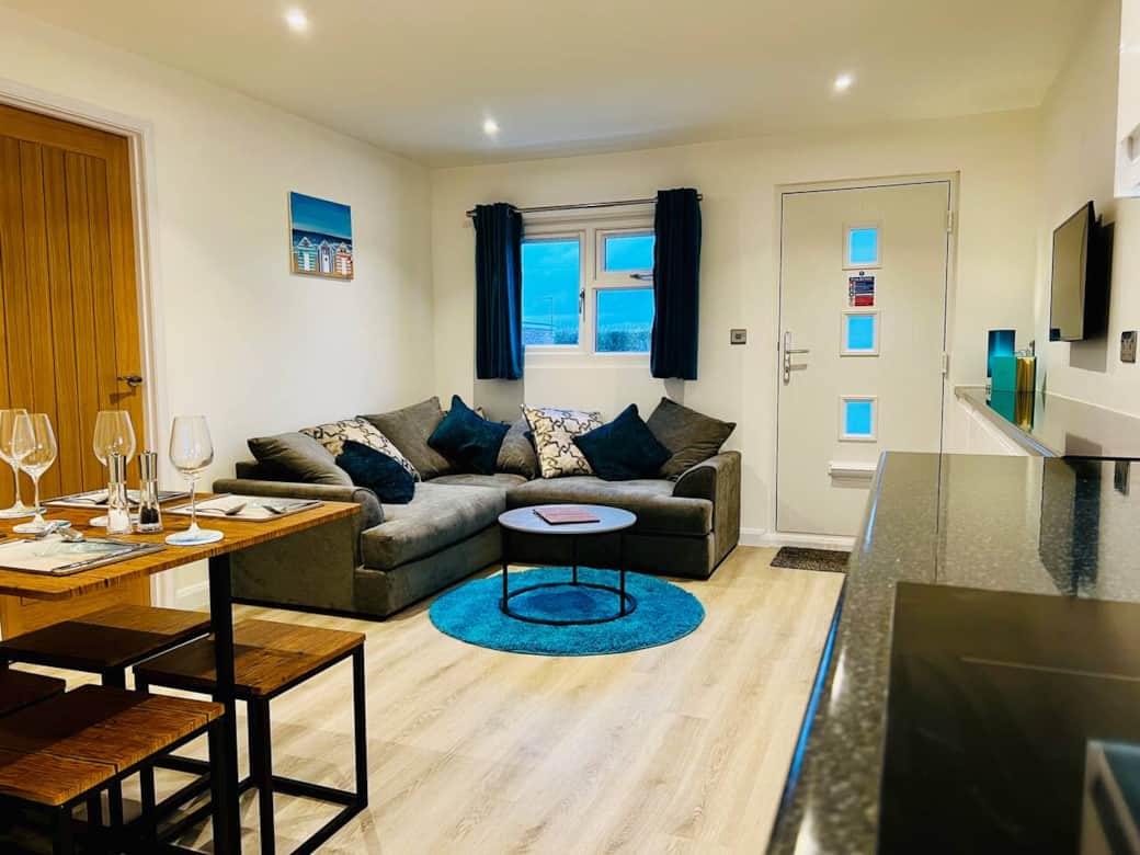 Bright open-plan living area with comfortable seating and Smart TV Bright open-plan living area with comfortable seating and Smart TV