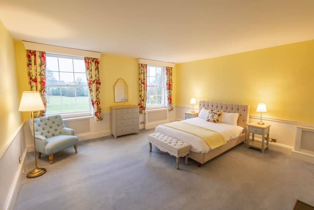 Old Rectory, bedroom 3, view of bed, accent chair & windows