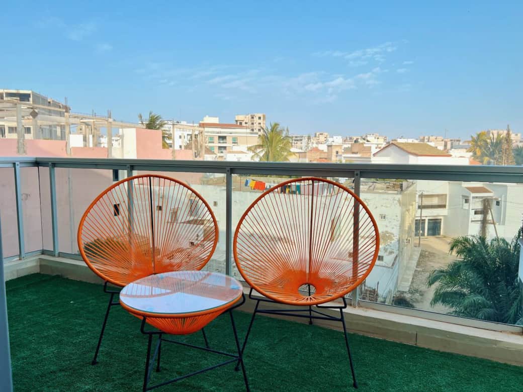 Immerse yourself with Dakar's vibes on our charming balcony,  providing stunning views and sunsets over the Almadies.