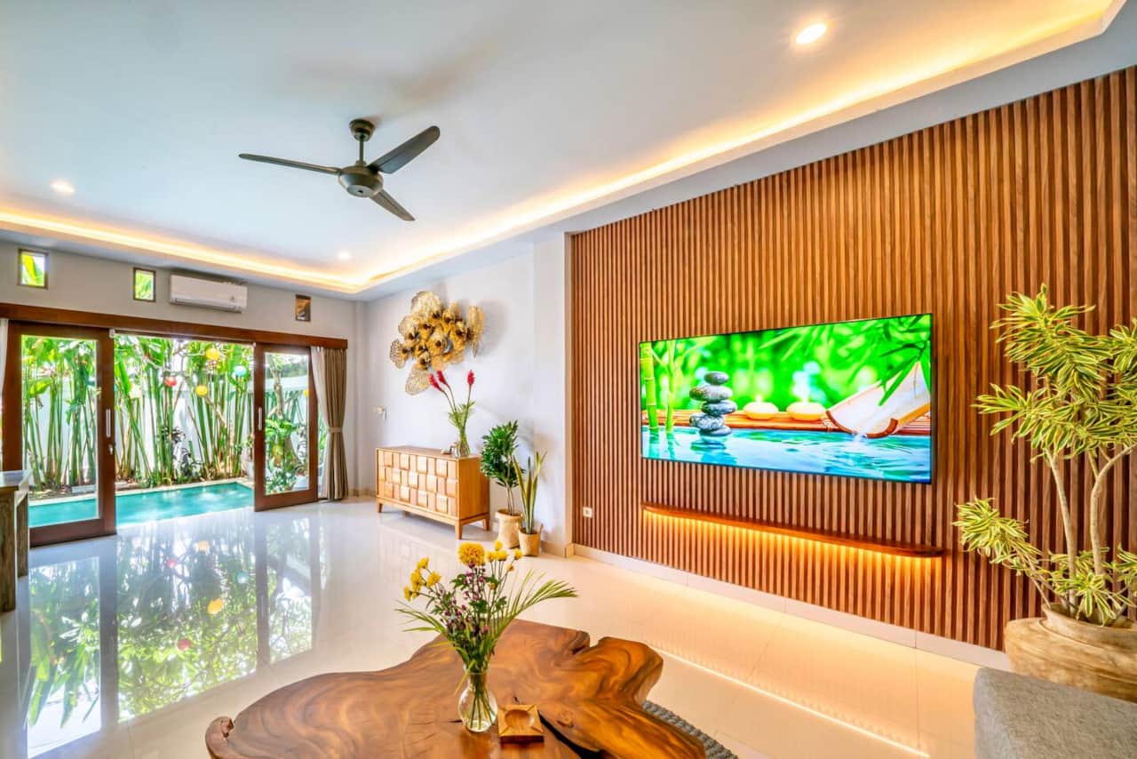 Open living area with pool access and tropical design