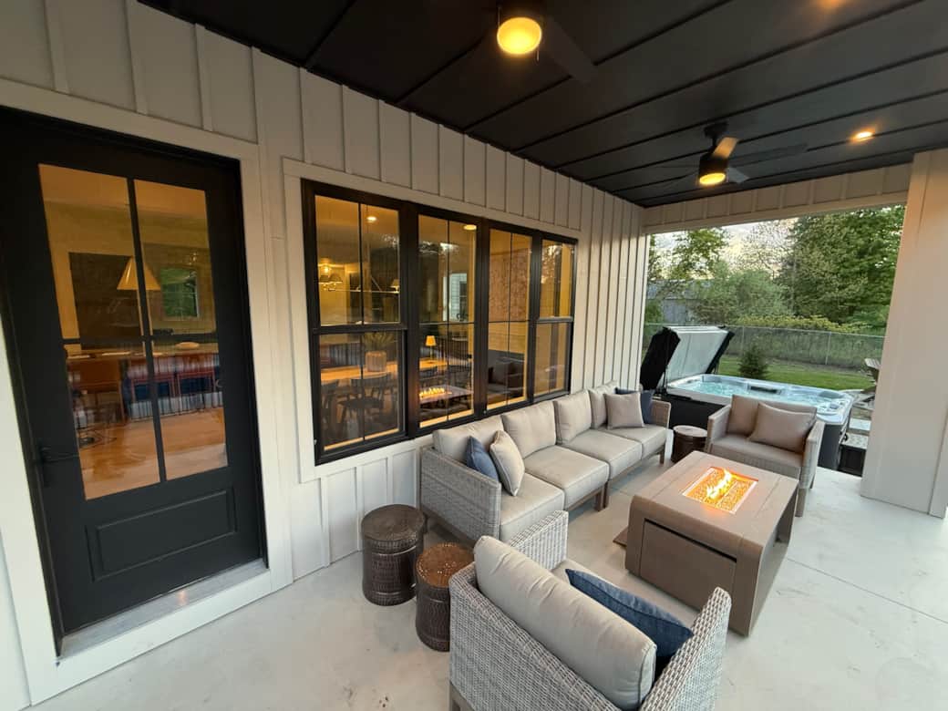 Patio with firepit table overlooks the pool 