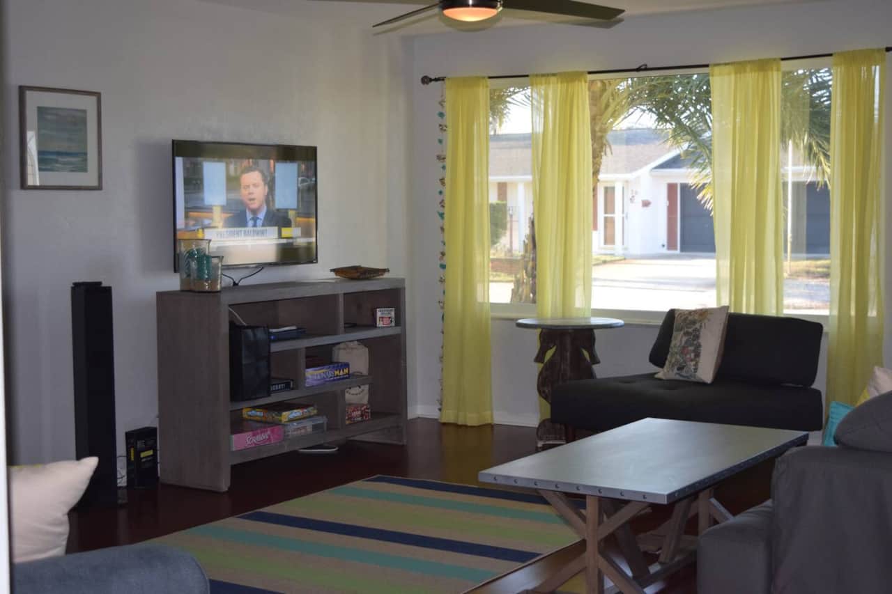 View into the living room and outdoors.  Great colors, seating and entertainment.