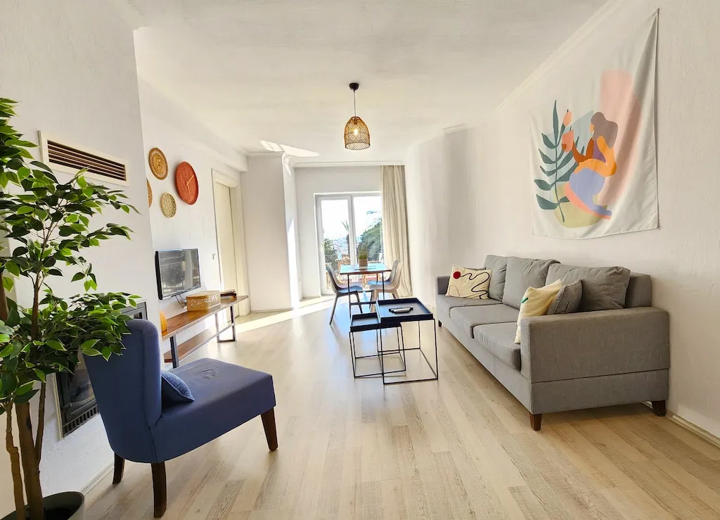 Living room featuring a sofa, chair, coffee table, and wall art in Apart Guney 7, Gocek.