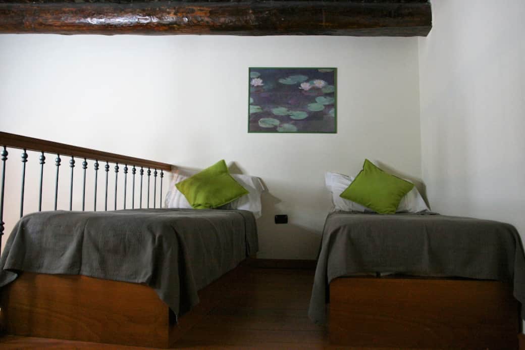 Two single beds on the mezzanine of the living room